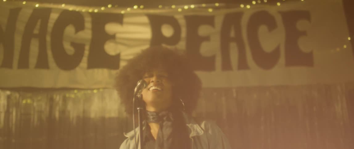A woman sings and performs on stage