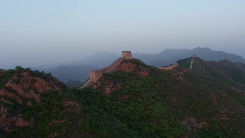 A wall stretches across a tall mountain