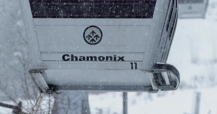 A ski lift is operating on a snowy day