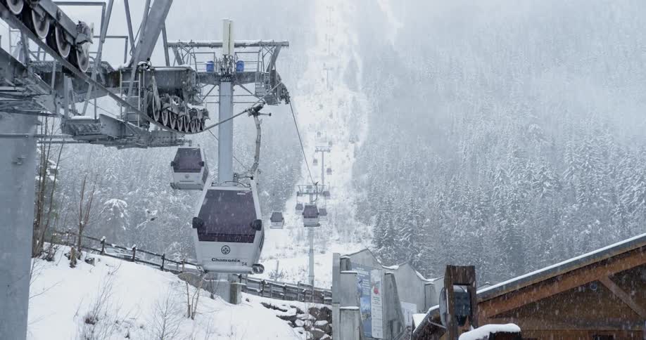 The ski lifts move along in the snowy weather
