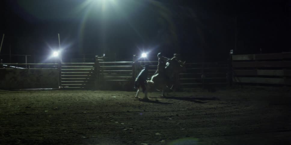 A man rides a bull in a rodeo