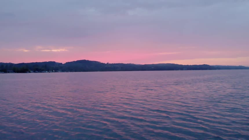 The sun is setting over the river