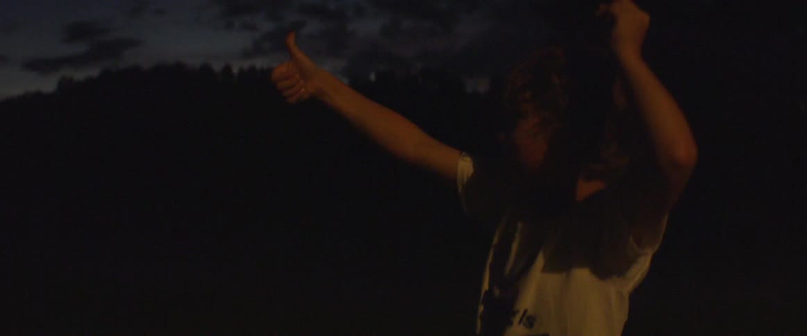 A child raises his thumb with a firefly on it