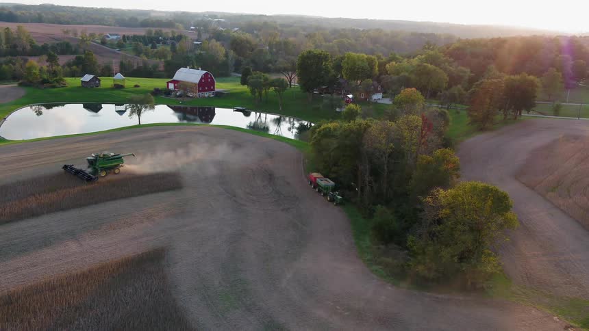 A tractor is working the fields on the farm