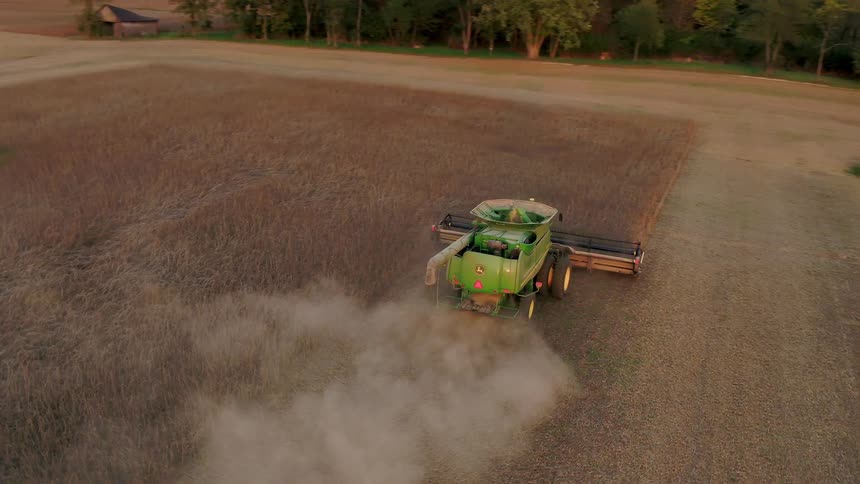 Farmer combining the wheat on a sunny day