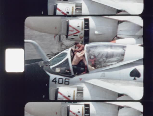 Two people are cleaning the windows on a jet