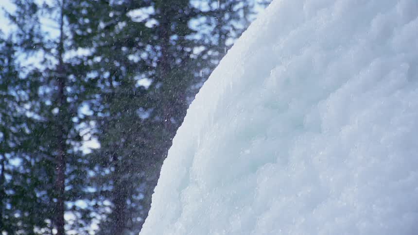 Water is dripping on the ice causing a mist to fall off