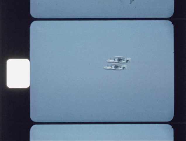 Two planes fly high in the cloudy sky
