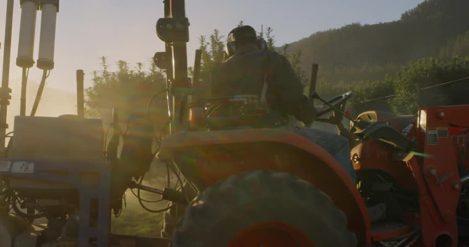 A man slowly turning a tractor