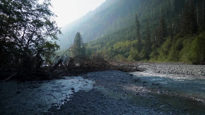 Shallow stream trickling over a rocky area on a hazy day