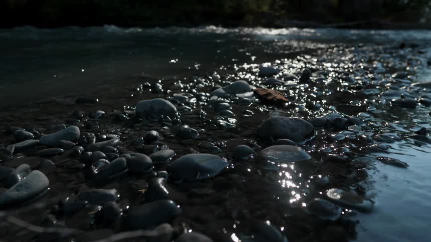 A river is trickling over stones as it flows