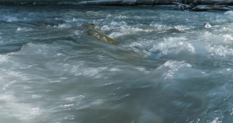Water flows rapidly down a stream