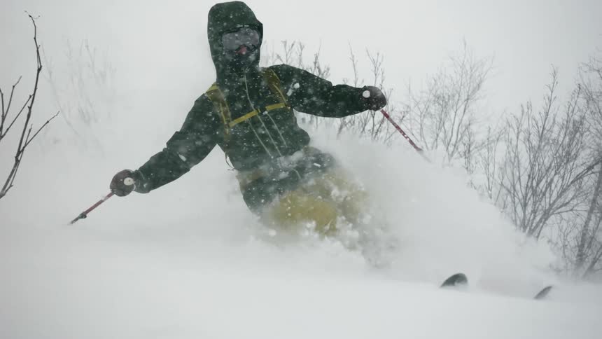 A skier turns through deep snow