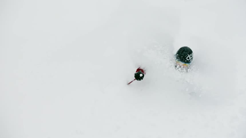 A skier turns through the deep snow
