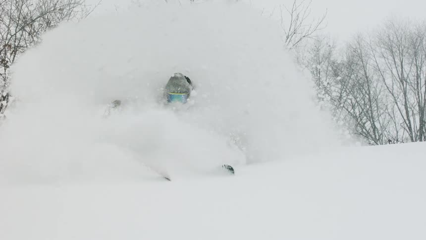 A skier turns through the snow