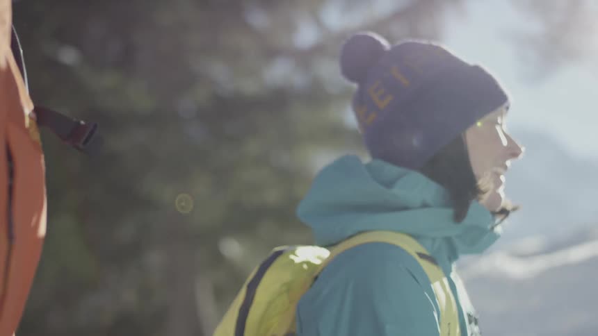 Hikers walk in a snowy forest