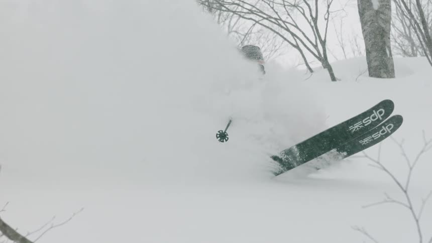 A skier glides over snow