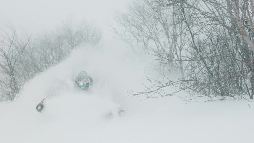 A skier turns through the snow