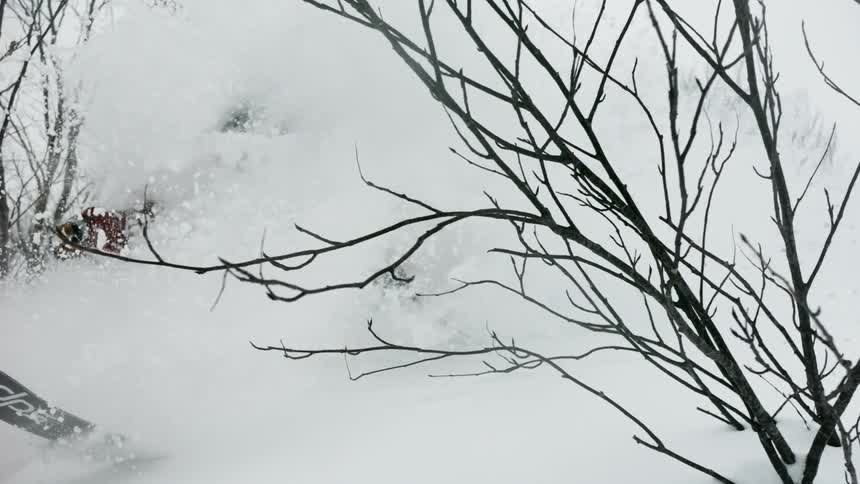 A skier turns through very deep snow
