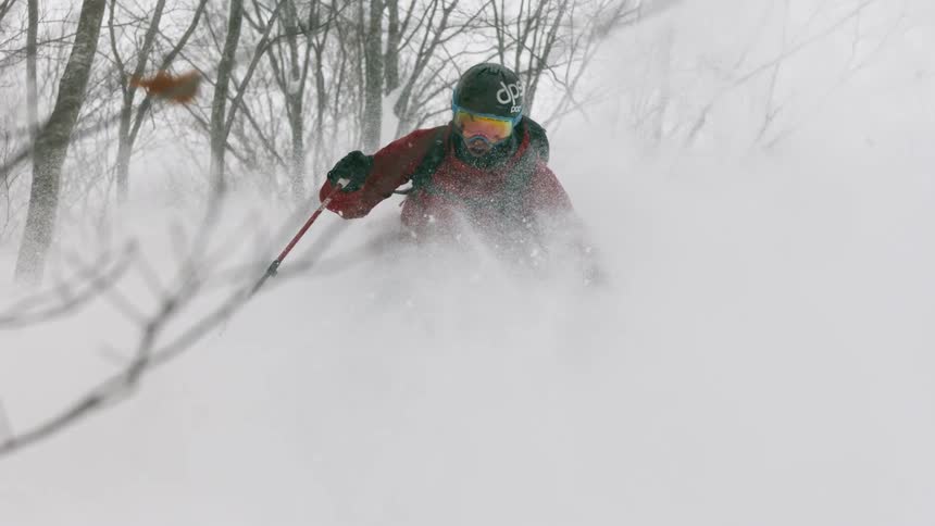 A skier turns through deep powder