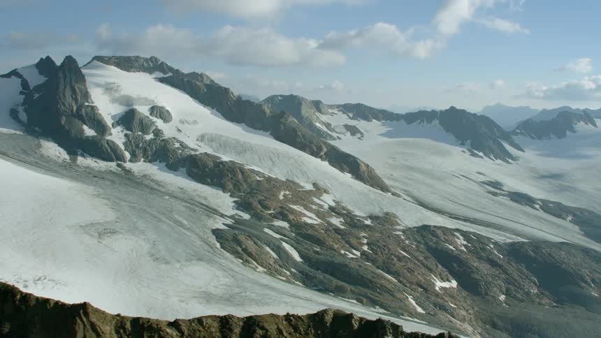 Snow covers some of the slopes of the rocky peaks