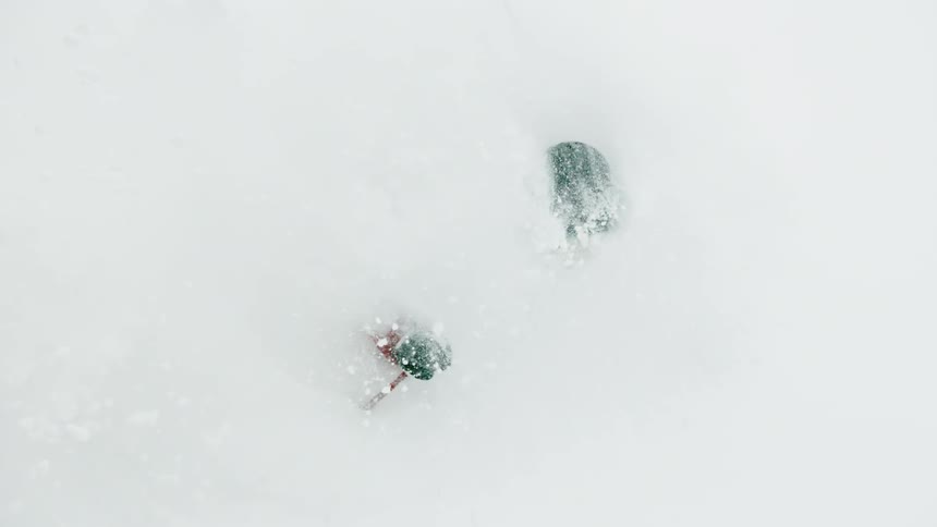 A skier turns through the very deep snow