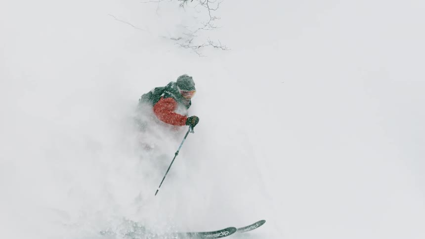 A skier turns through the snow