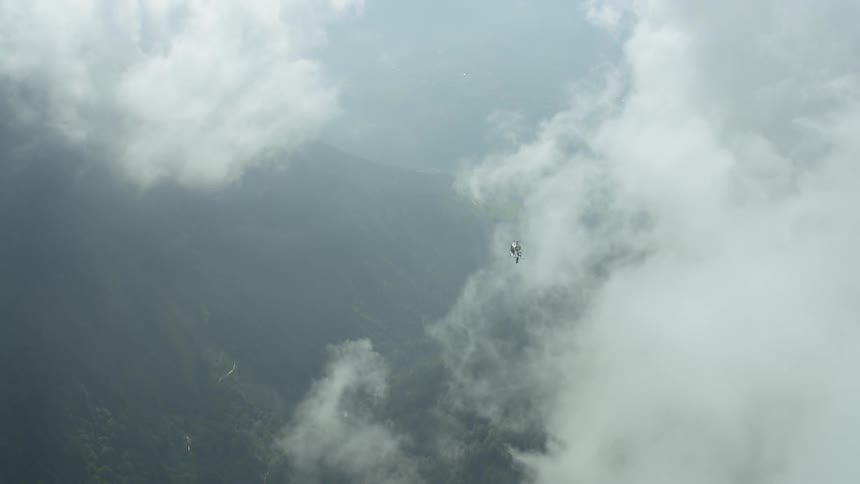 The aircraft moves around spinning in the clouds