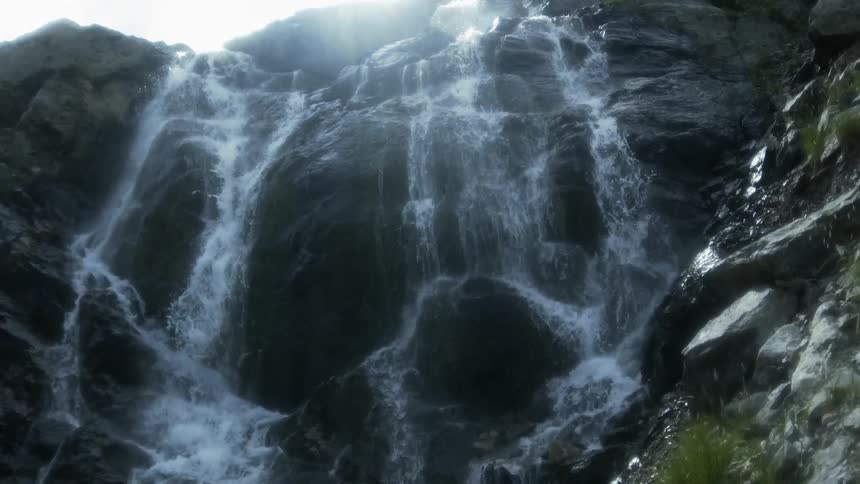 A waterfall flows over a rocky cliffside