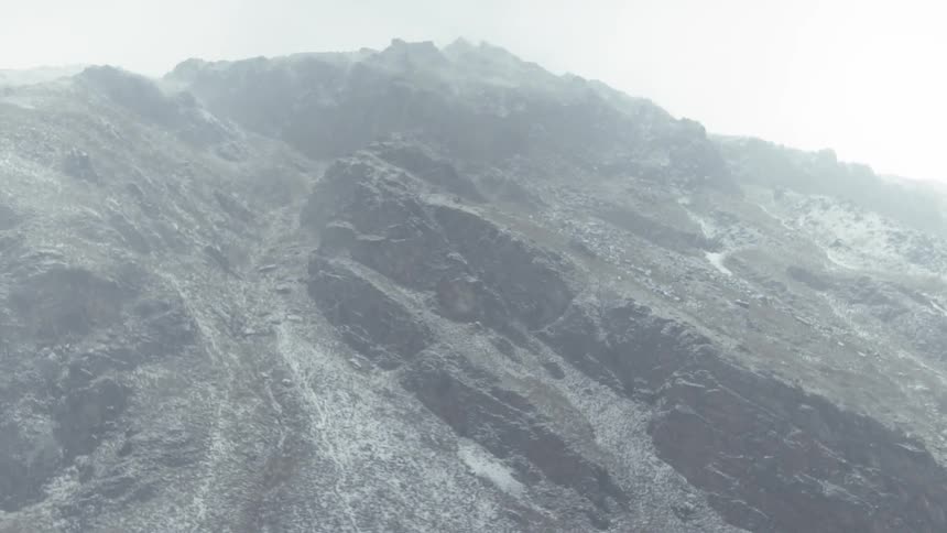 Clouds float around a mountain peak