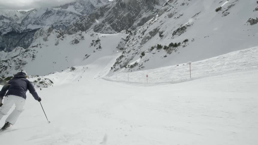 A skier descends down the slope