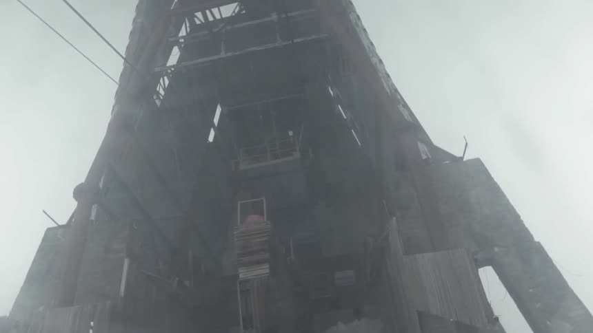 Snow flurries are blowing across a ski lift tower during the day