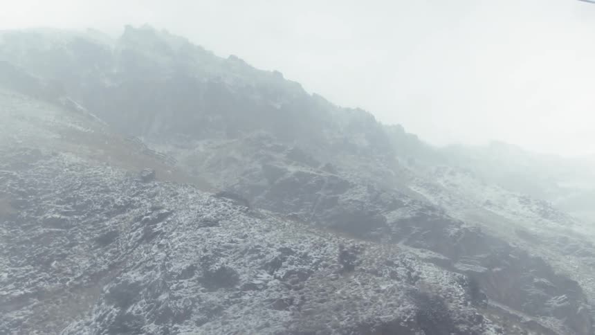 The fog is rolling over the snow covered mountains