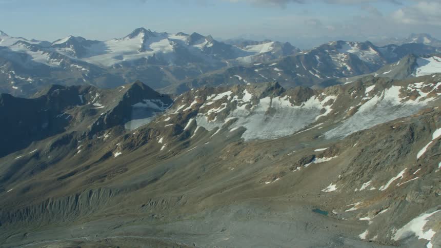 Snow covered mountains under a cloudy sky
