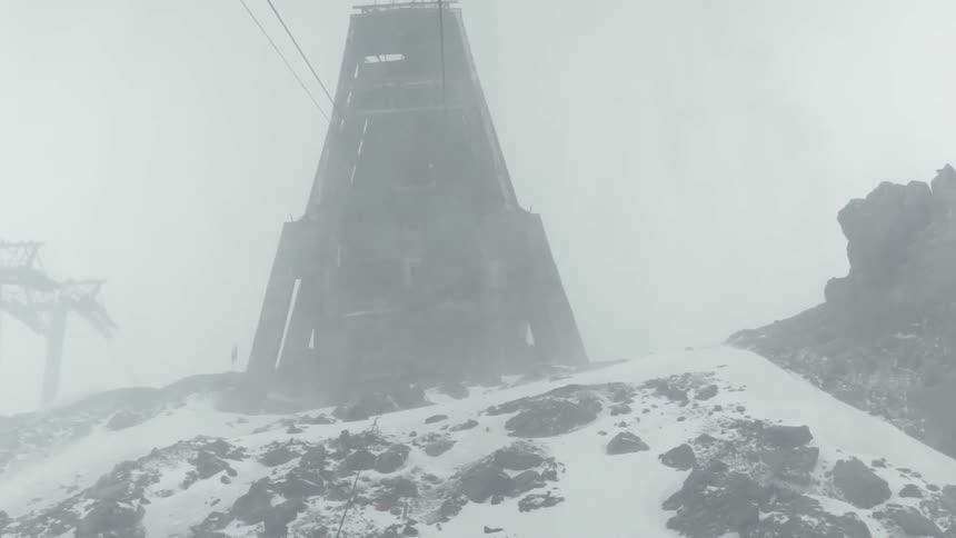 Light snow swirling in the air near a ski-lift station