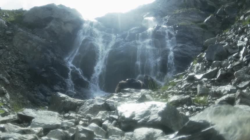 The waterfalls pour over the rocks in the spring