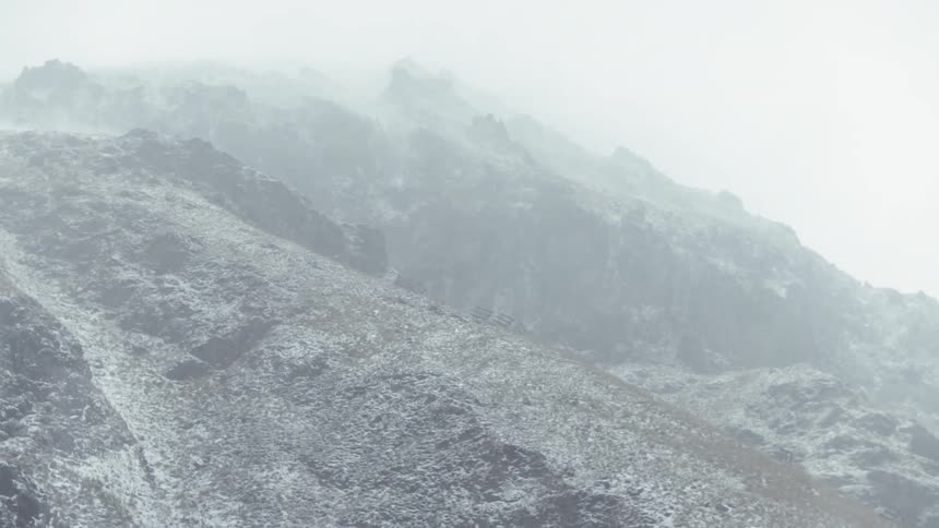 Snow falls in the mountains