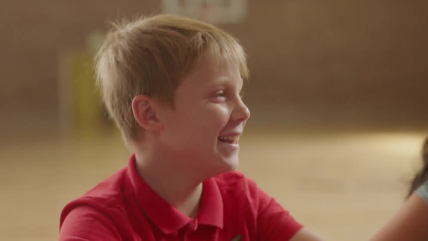 A young boy laughs and smiles