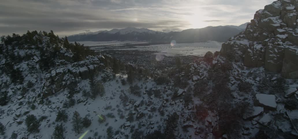 The sun sets over snowy mountains