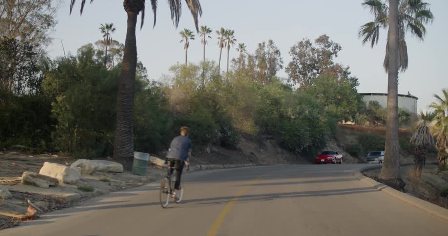 A person rides their bicycle down the street