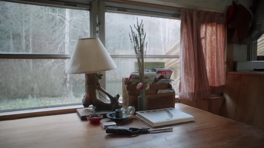 A lamp and miscellaneous objects sit on a table