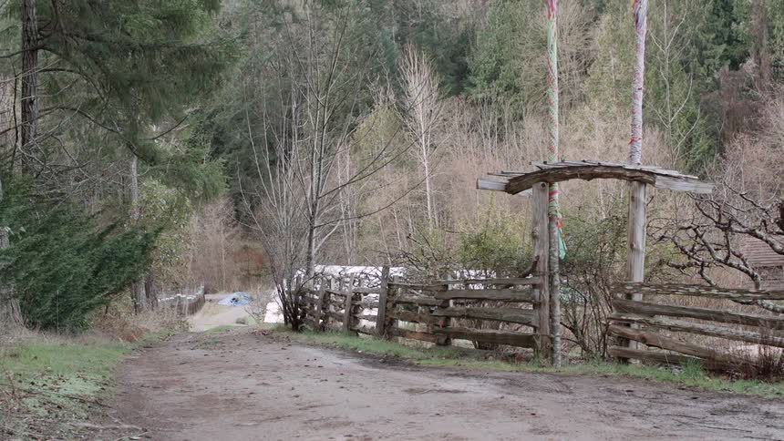 A wood fence sits in a rural area