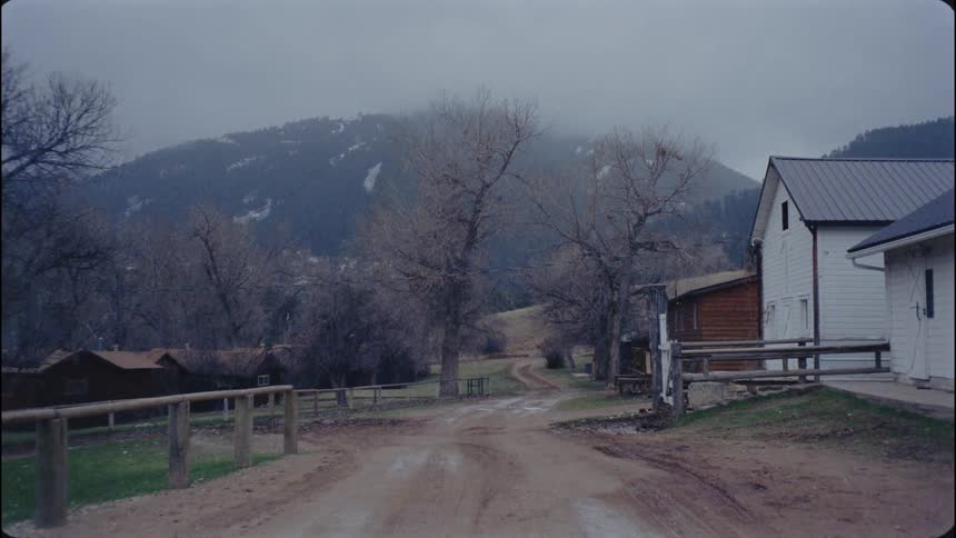 A dirt road runs through a farm