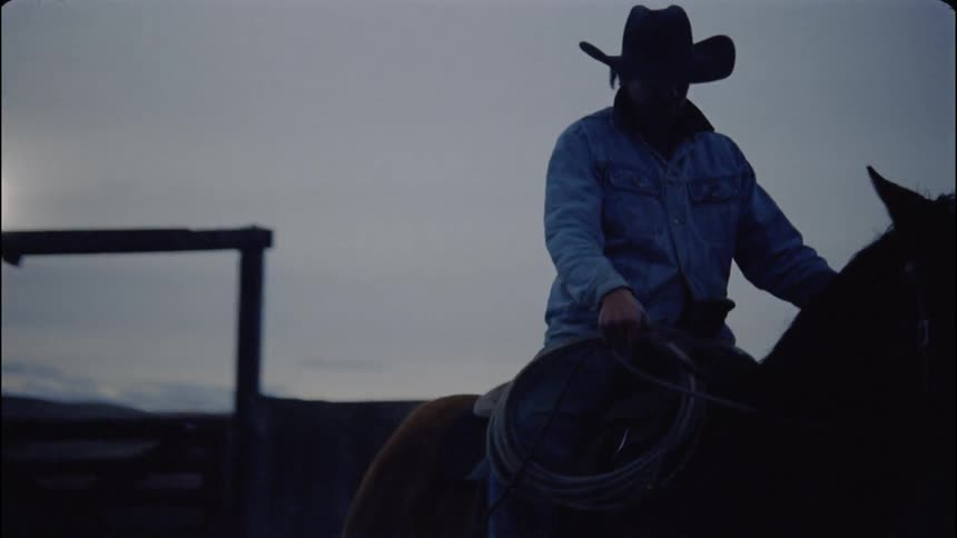 A man is riding the horse at sunset