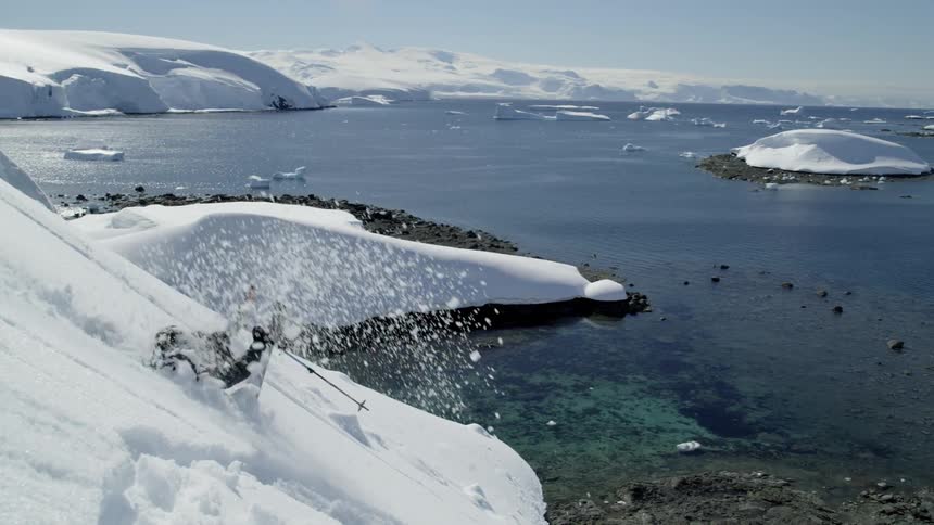 Man takes a tumble while skiing down a snowy mountain