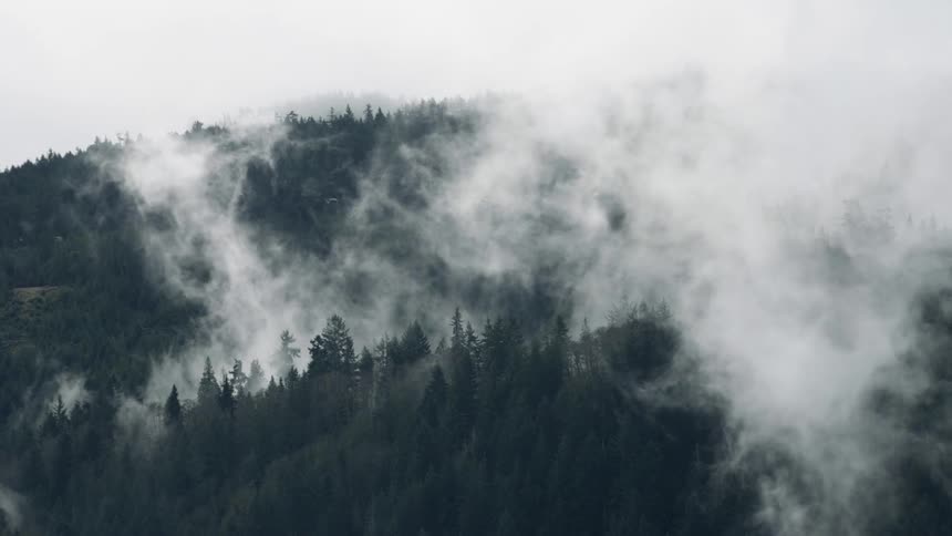 Clouds and steam pours from a mountain