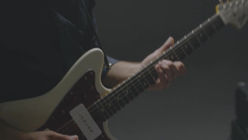 A man plays a bass guitar