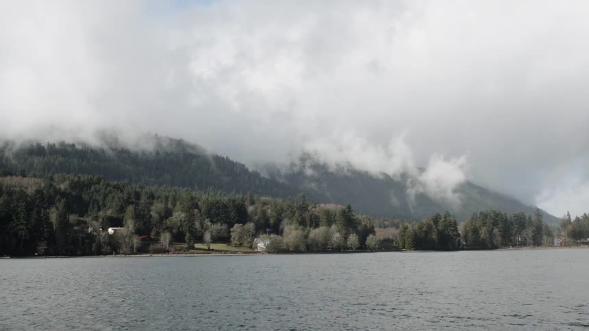 Clouds float above a mountain lake