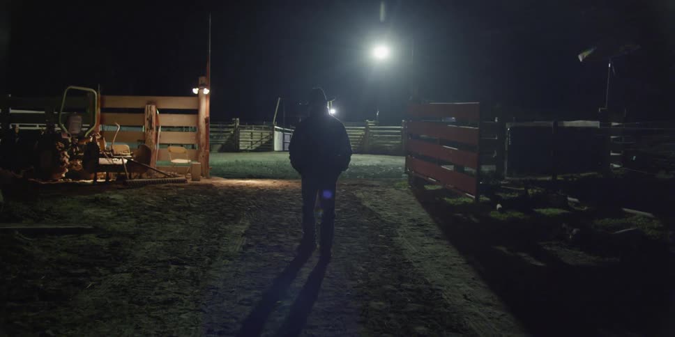 A man walks into a rodeo pen