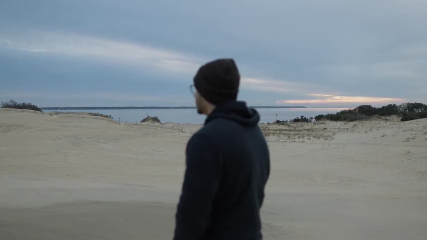 A man walks on the beach shore